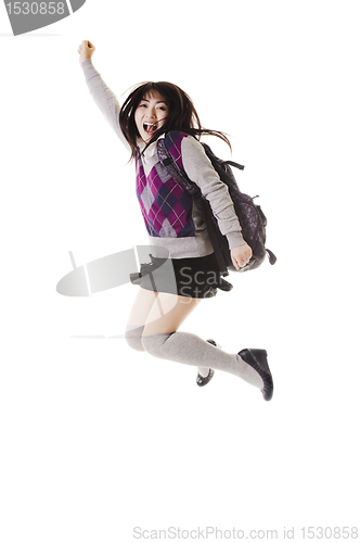 Image of Chinese school girl jumping into air.