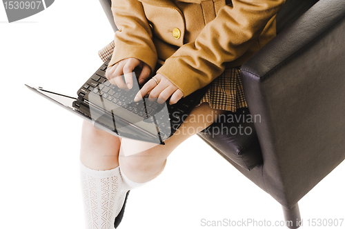 Image of Chinese school girl working on a laptop.