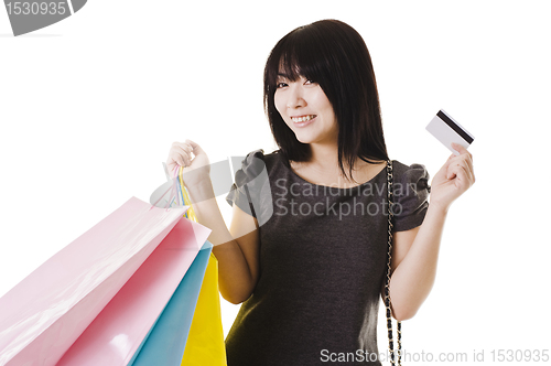 Image of Chinese woman holding shopping bags and credit card.