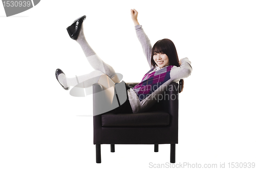 Image of Excited Chinese student in a leather chair.