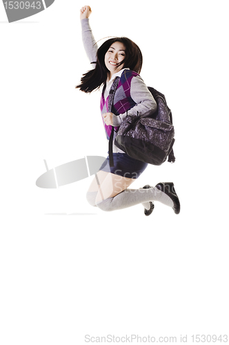 Image of Chinese school girl jumping into air.