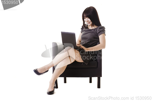 Image of Attractive Chinese woman working on a netbook.