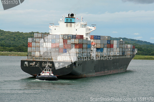 Image of containership and tug