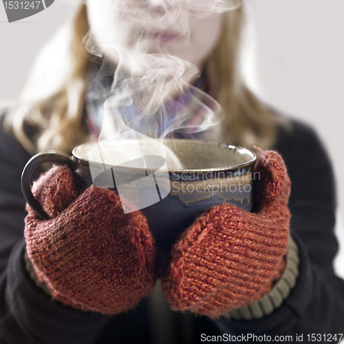 Image of woman and hot steaming cup