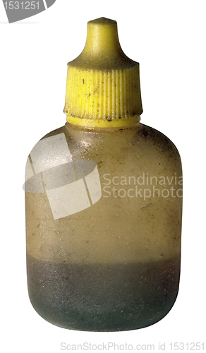 Image of dirty old oil bottle with yellow cap