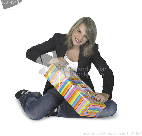 Image of sitting girl unwrapping a present