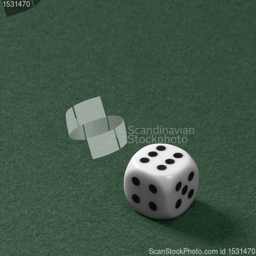 Image of die on green felt