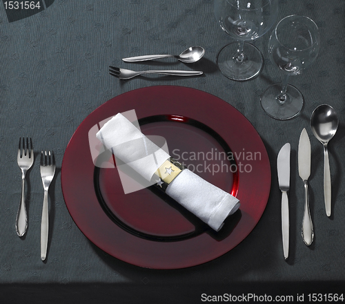 Image of noble place setting on dark tablecloth