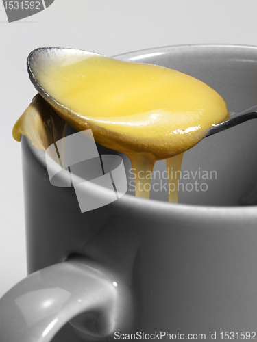 Image of cup and honey spoon