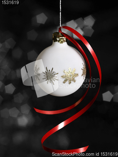 Image of white Christmas bauble in dark back