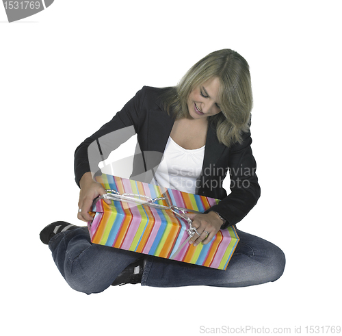 Image of sitting girl unpacking a present