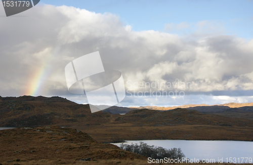 Image of scottish scenery with rainbow and dramatic sky