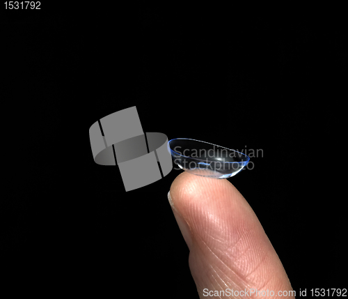 Image of contact lens on finger tip