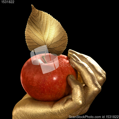 Image of golden hand and apple