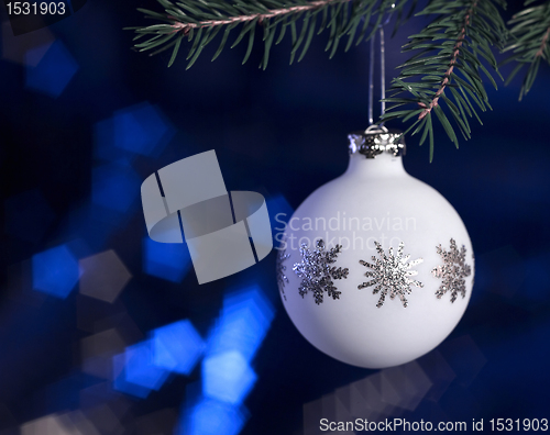 Image of white Christmas bauble in dark blue back