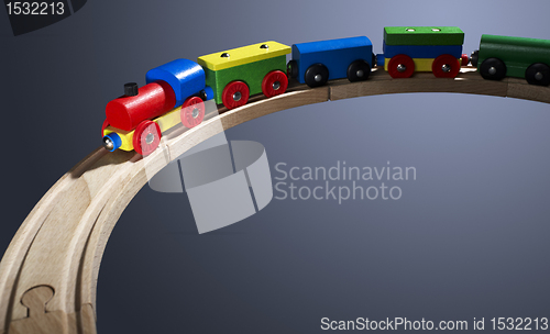 Image of colorful wooden toy train on tracks