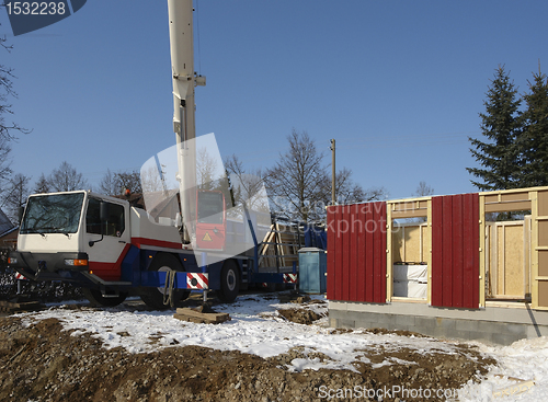 Image of wooden house construction in sunny ambiance