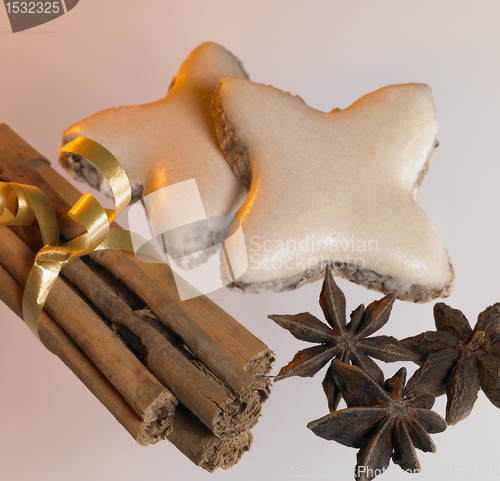 Image of christmas theme with cinnamon sticks, stars and spice