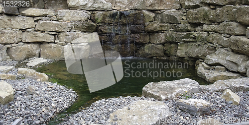 Image of stone wall and pond detail