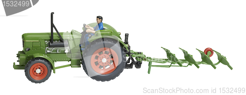 Image of nostalgic toy tractor with plowshare