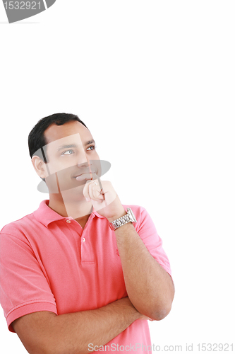 Image of handsome hispanic man looking upwards at copyspace thinking 