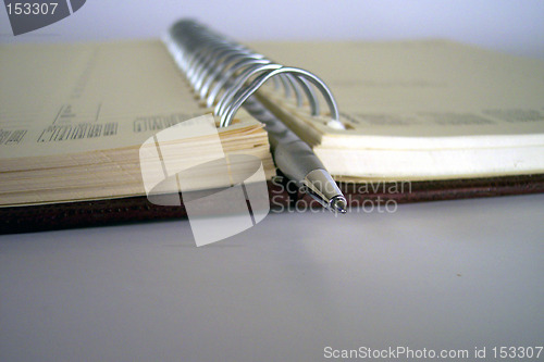 Image of pen in the middle of notebook