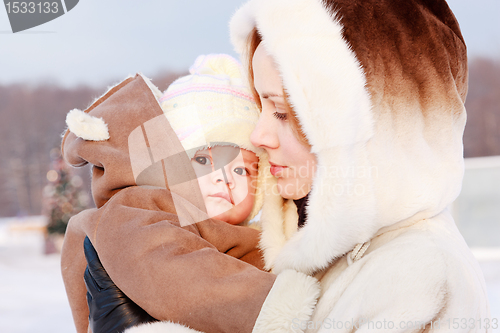 Image of Mother with baby in winter