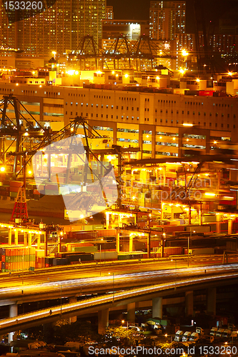 Image of Port warehouse with cargoes and containers at night