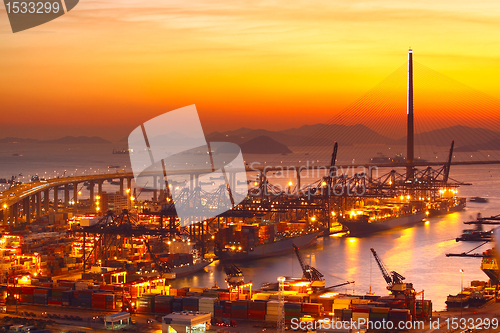 Image of Port warehouse with cargoes and containers at sunset 