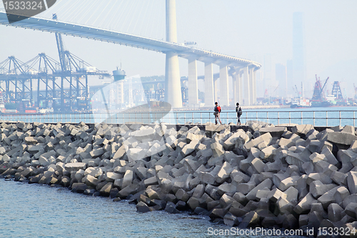 Image of two people walking on breakwater