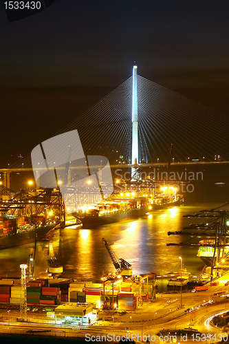 Image of Port warehouse with cargoes and containers at night