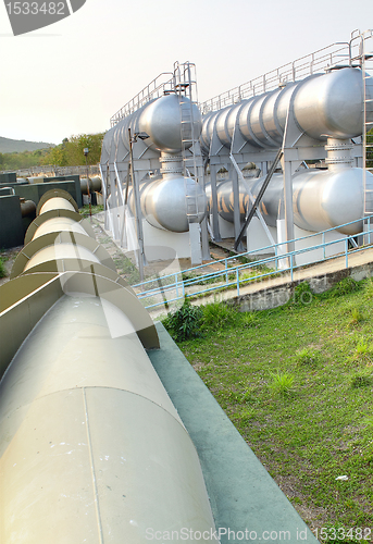 Image of oil tanks and pipes outdoor at day 