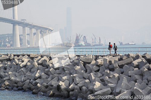 Image of two people walking on breakwater