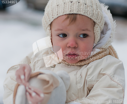 Image of Little girl in hat walks