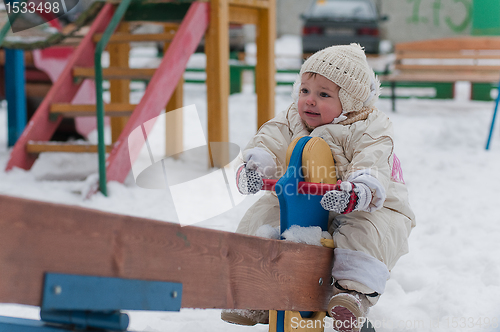 Image of Little girl sits on the swing