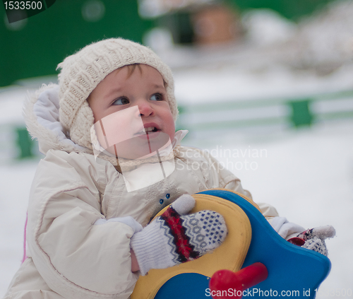 Image of Little girl sits on the swing