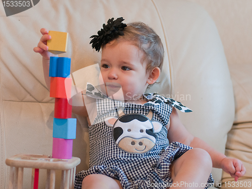 Image of Little girl plays with cubes