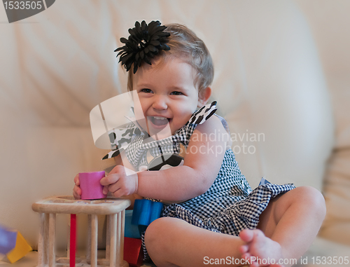 Image of Little girl plays with cubes