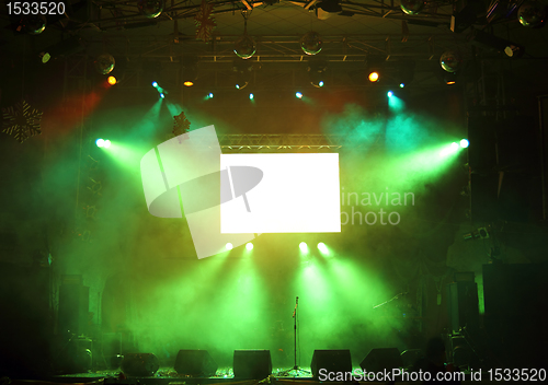 Image of empty stage and screen in the rays of light