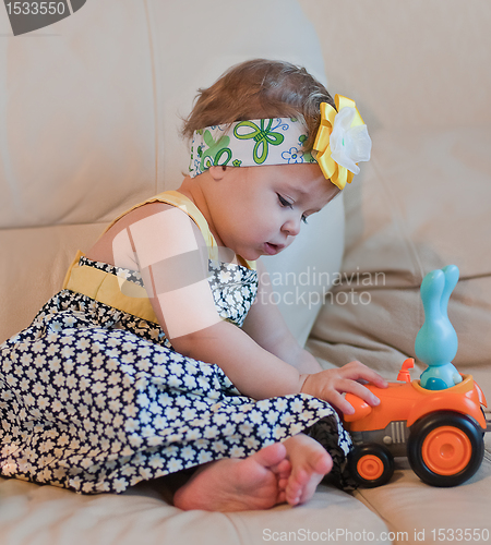 Image of Little girl plays with her toy
