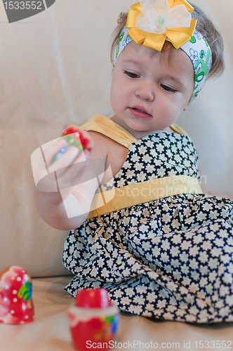 Image of Little girl with matrioshka in her hand