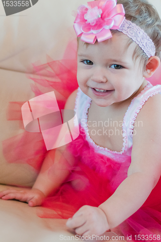 Image of Little smiling girl in the pink dress