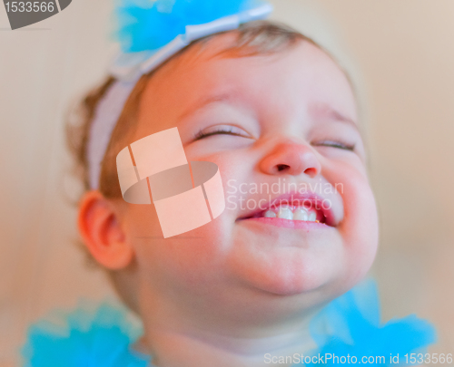 Image of Little smiling girl with closed eyes