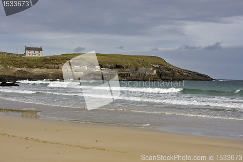 Image of sandy coast with single house in scotland