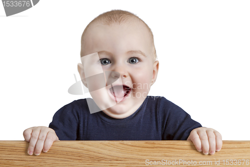 Image of young child holding wooden board