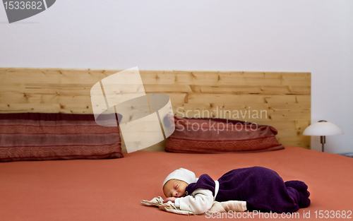 Image of nursling alone in huge bed