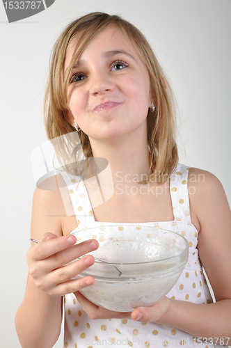 Image of happy child with a bowl of milk porridge