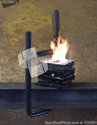 Image of burning vise and hard disks