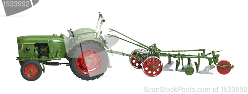 Image of nostalgic toy tractor with plowshare