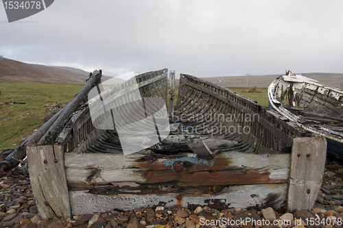 Image of coastal scenery with small rotten boat